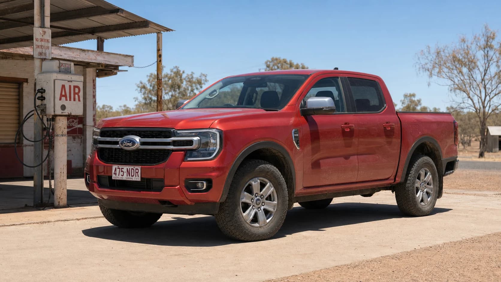 Red Next-Gen Ford Ranger parked on all-terrain tyres beside an air stand at a remote Queensland roadhouse