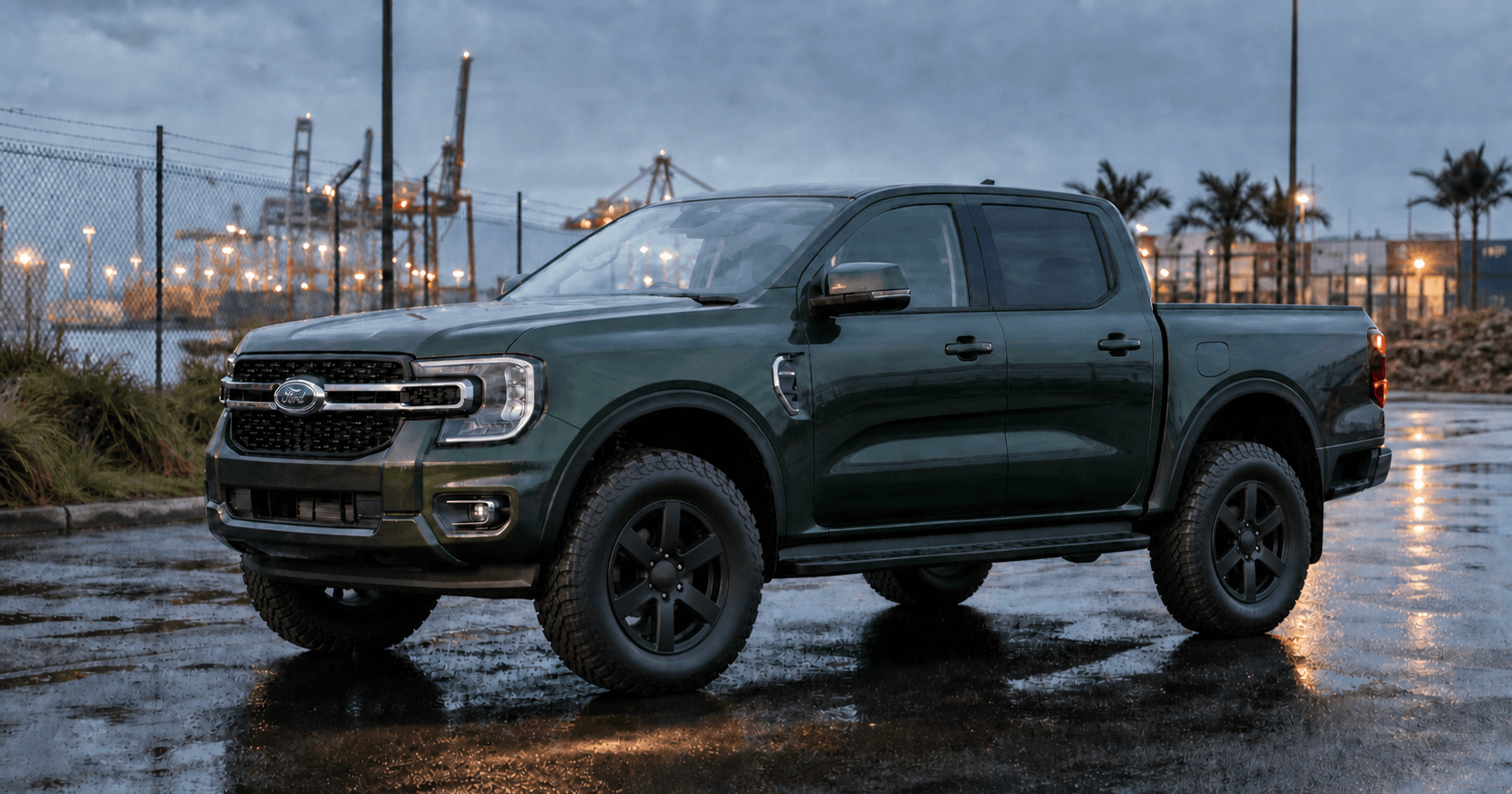 Green Next-Gen Ford Ranger on 33-inch-class all-terrain tyres on a wet Port of Brisbane industrial road