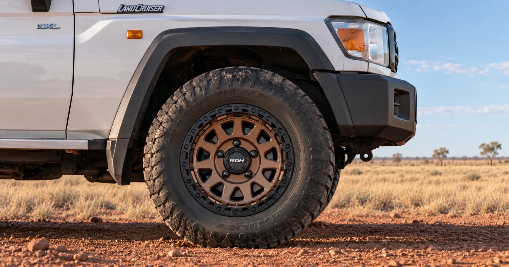 Front-wheel detail of a 2022 Toyota LandCruiser 79 GXL V8 double cab with ROH Assault wheels in Bronze Centre Black Lip