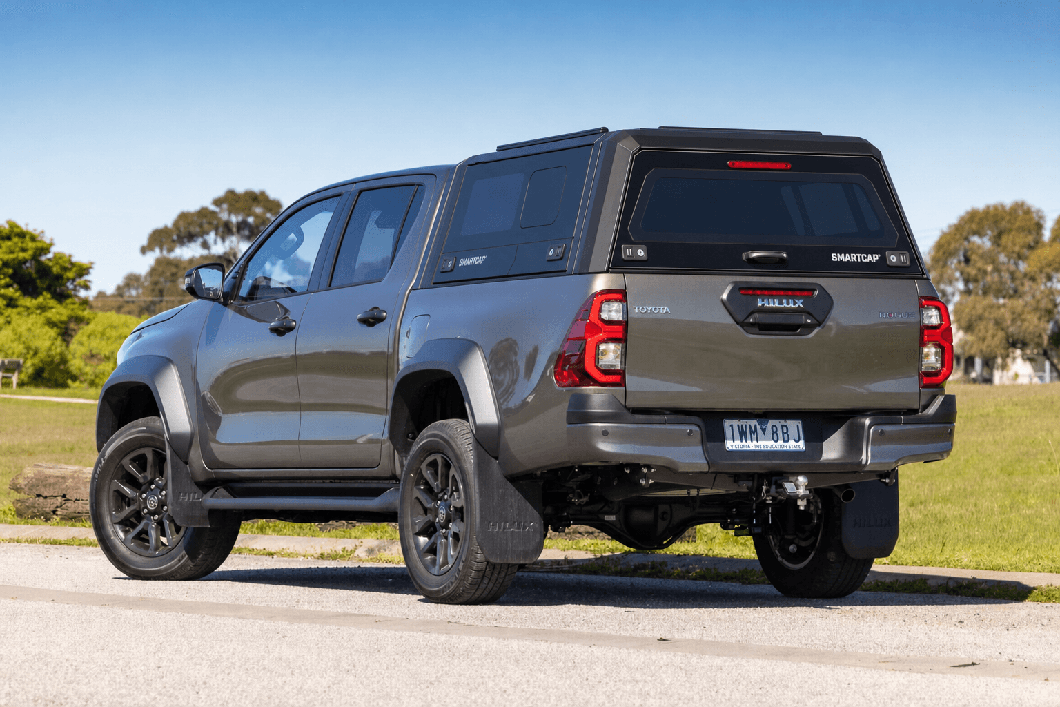 Grey Toyota HiLux Rogue with a black RSI SmartCap canopy, viewed from the rear passenger side