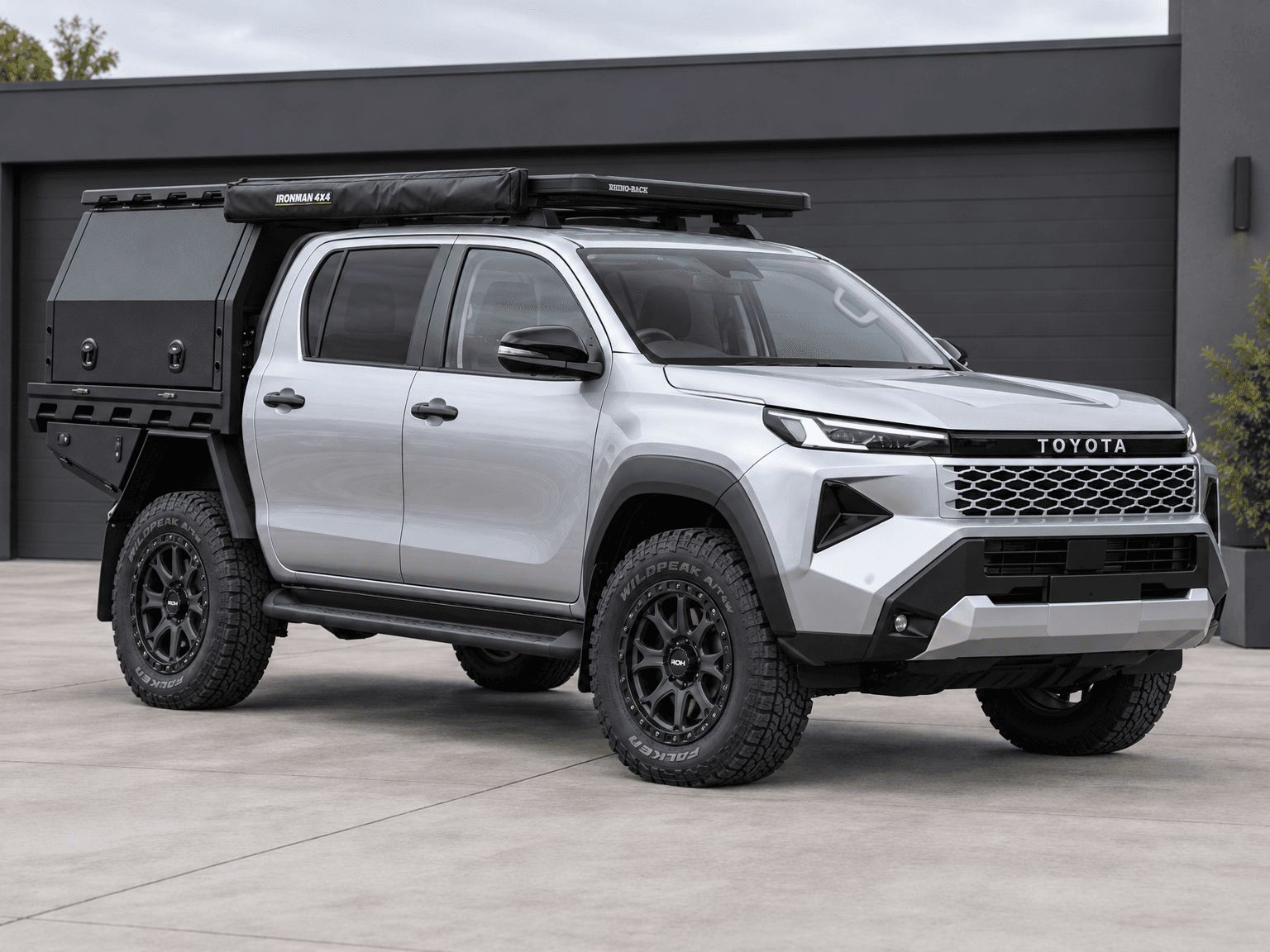 Silver Toyota ute with a closed Ironman 4x4 awning, roof rack and black canopy