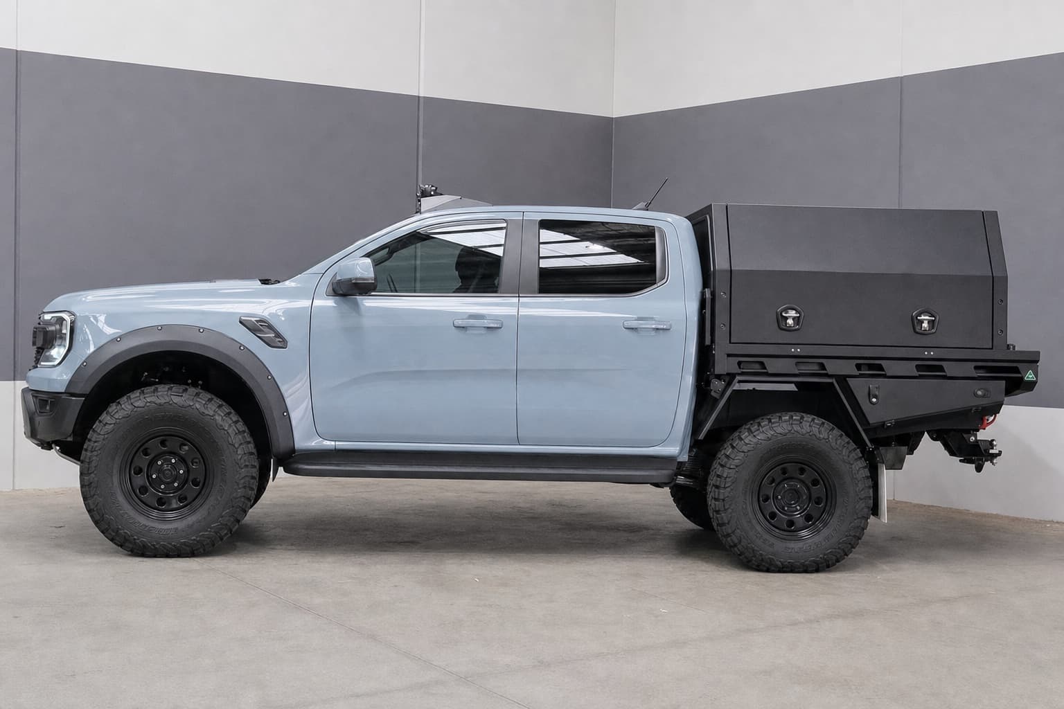 Light blue Ford Ranger dual cab visual concept with a nose-high stance, black steel wheels, all-terrain tyres and a black tray canopy