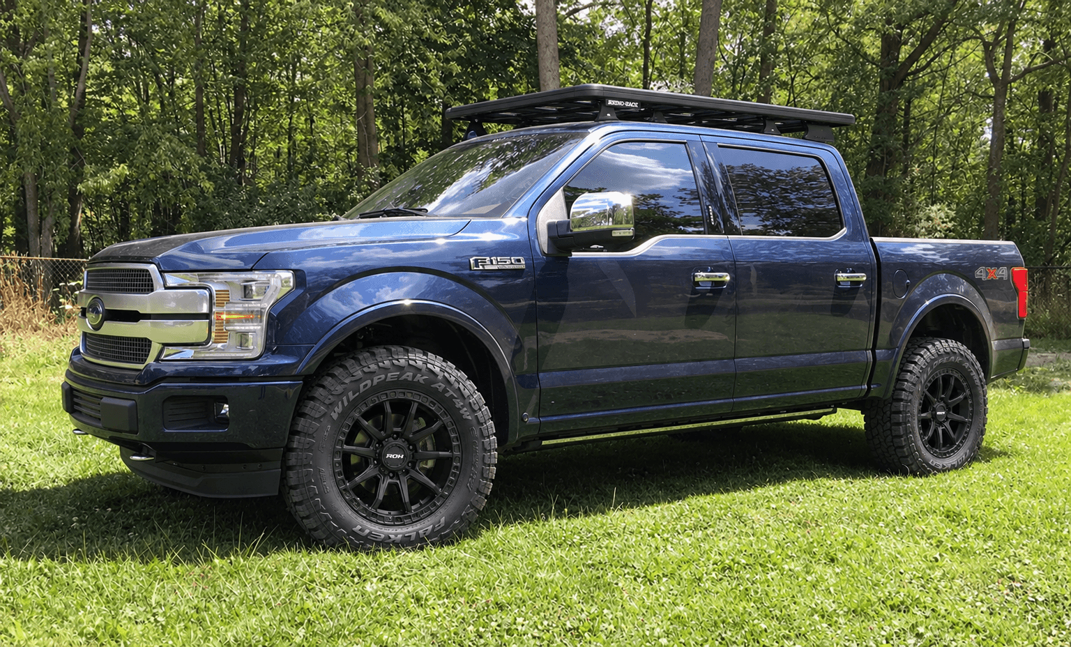 The blue Ford F-150 shown with black ROH Raid wheels, Falken tyres and a Rhino-Rack roof rack