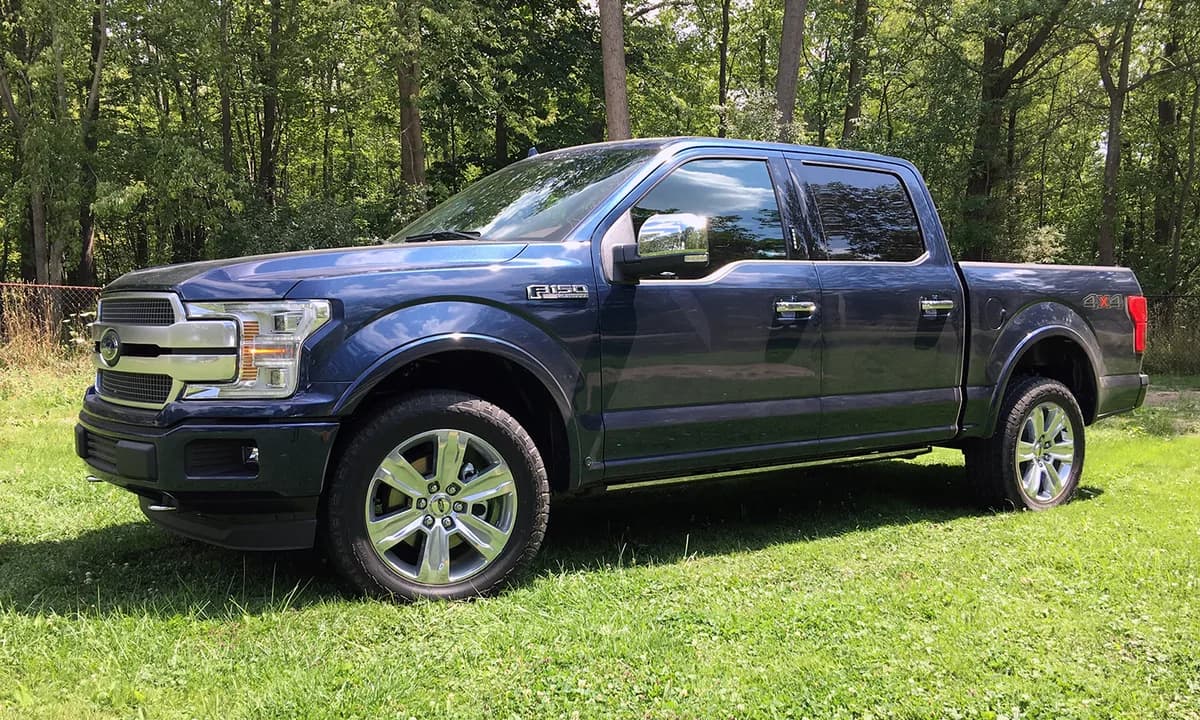 Original blue Ford F-150 with standard wheels and no roof rack