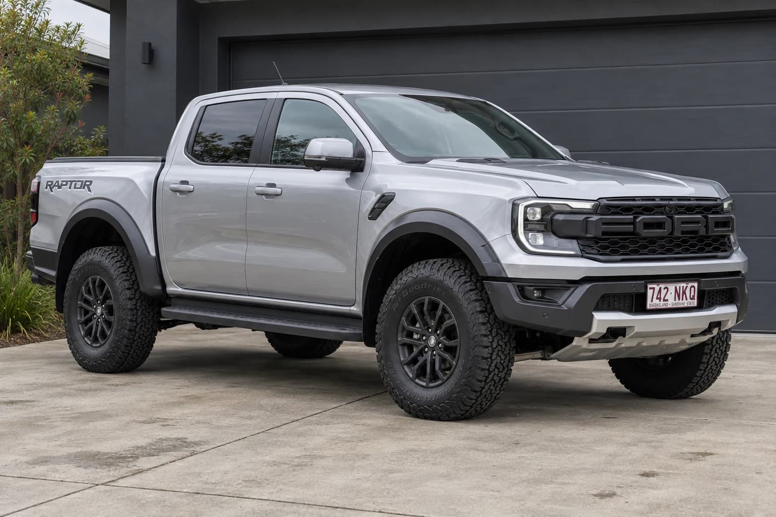 Generated stock silver Ranger Raptor starting image in the same driveway