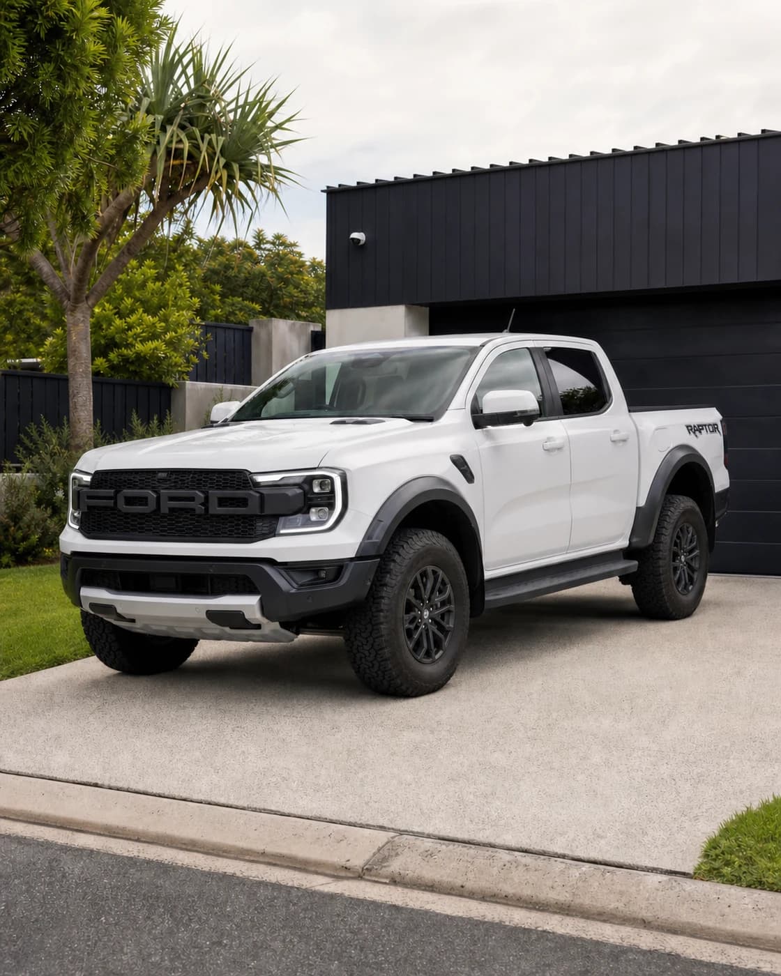 Stock white 2025 Ford Ranger Raptor photographed on a driveway