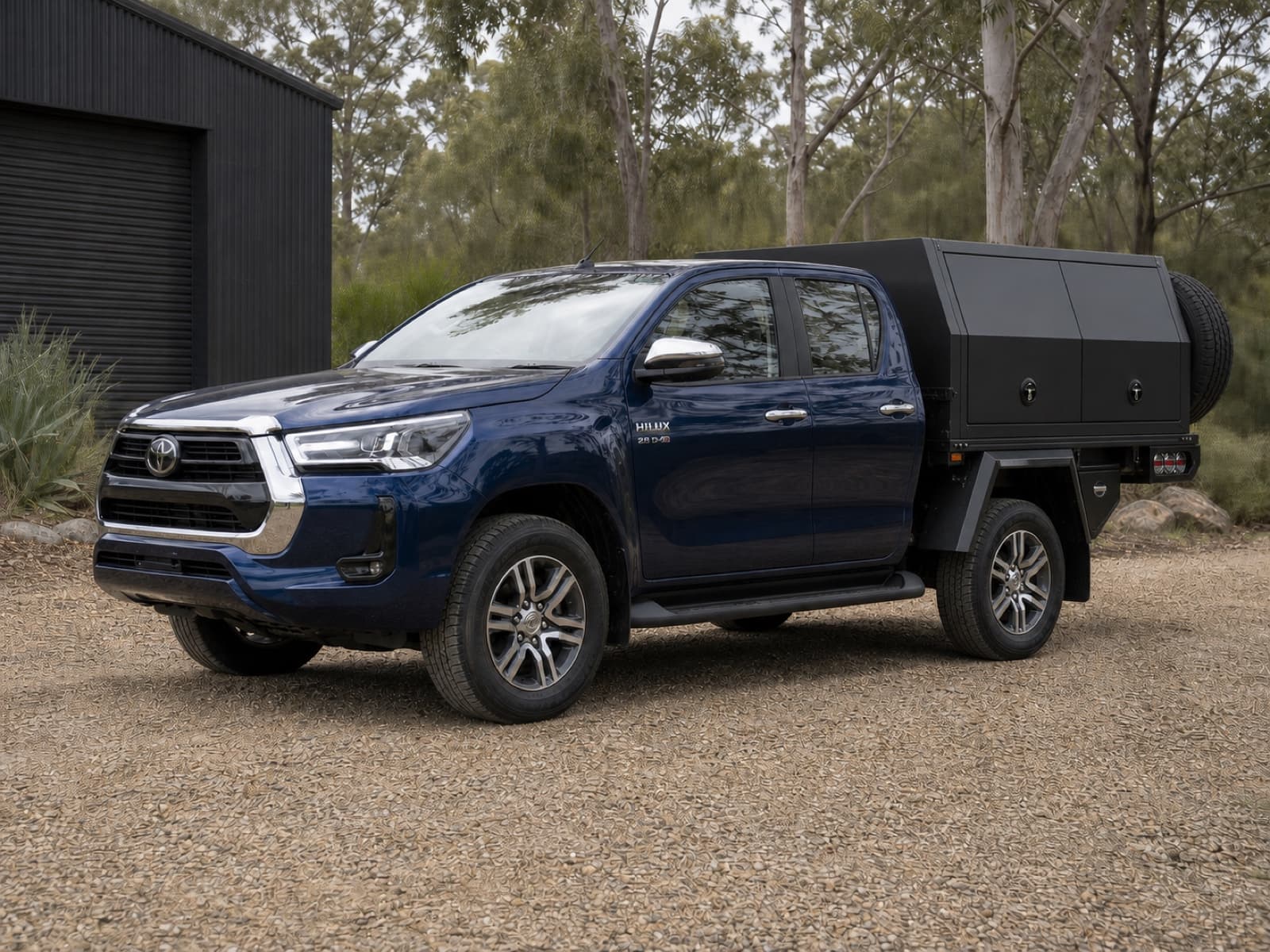 Dark blue Toyota Hilux N80 with a full touring tray and canopy
