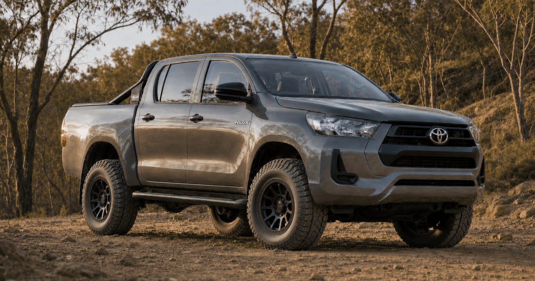 Graphite Toyota HiLux N80 fitted with large all-terrain tyres on 17-inch black off-road wheels