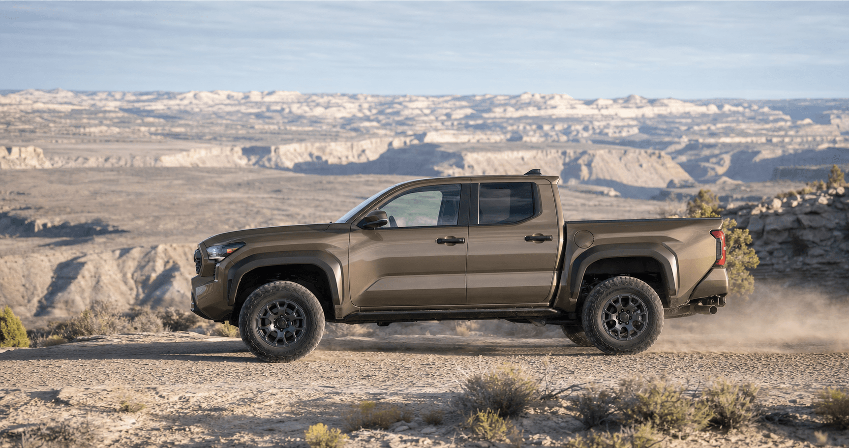 Bronze fourth-generation Toyota Tacoma running 33-inch all-terrain tires on a Utah desert trail