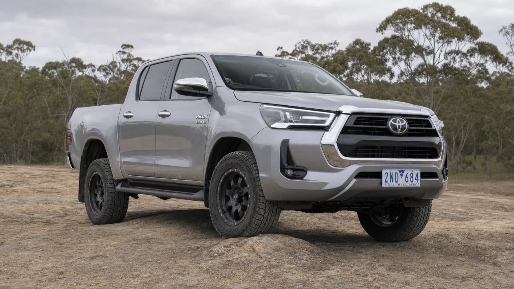 Silver Toyota HiLux N80 parked on 33-inch-class all-terrain tyres at a Victorian 4WD training area