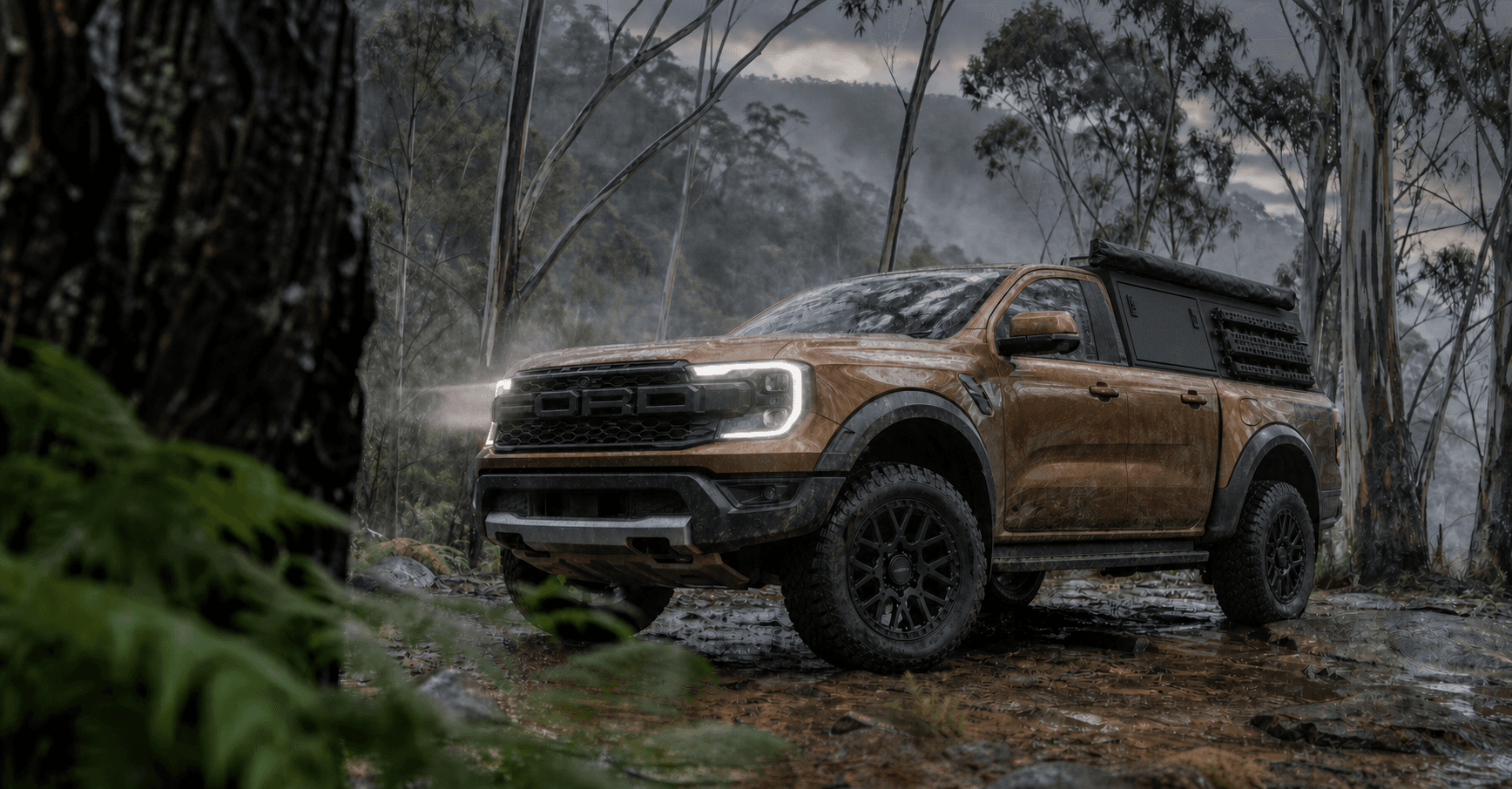 Brown Ford Ranger Raptor visualised with matte-black ROH Crawler wheels on a wet Blue Mountains forest track