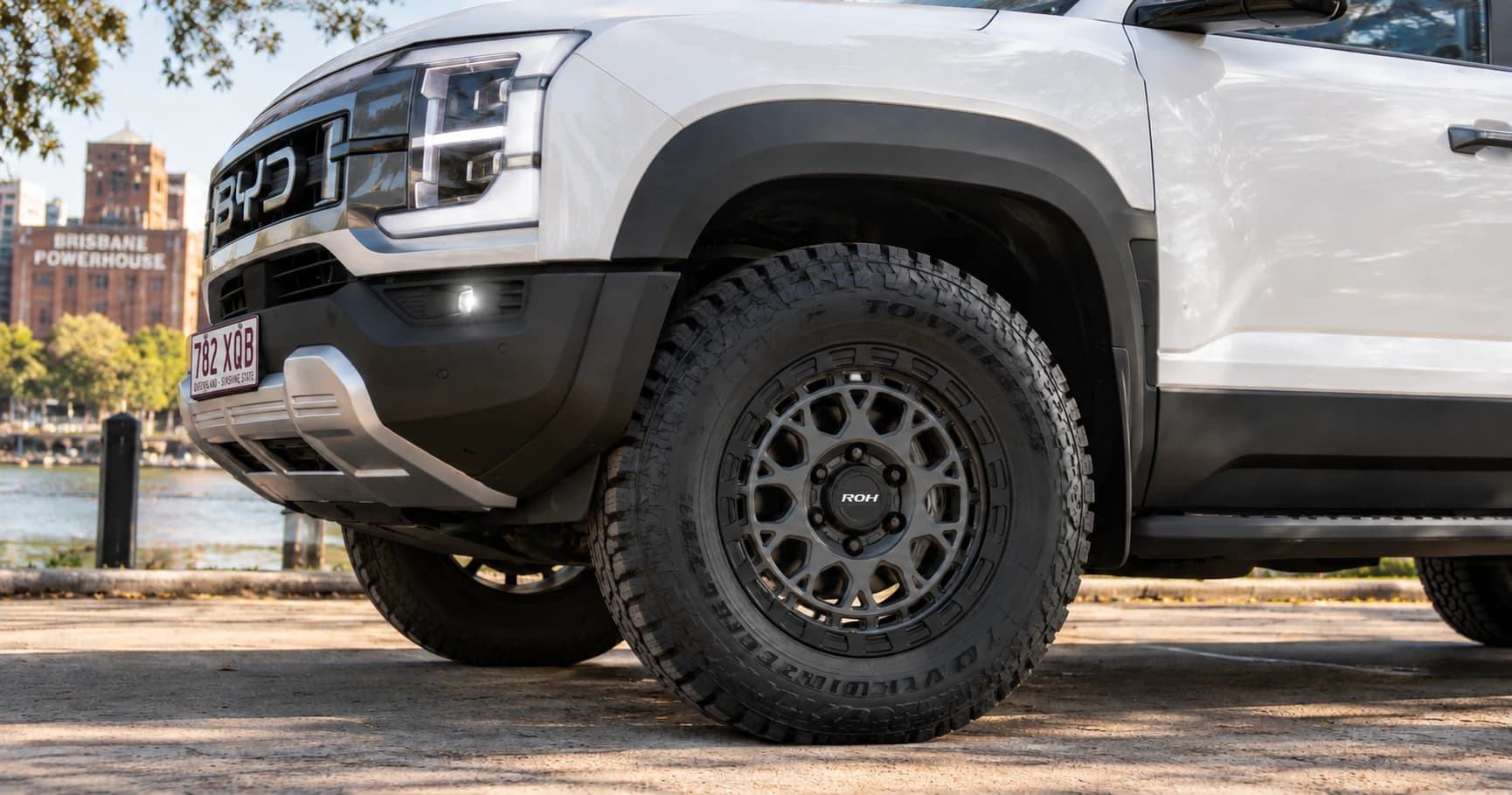 Front-wheel detail of a 2025 BYD Shark 6 Premium 4x4 dual cab with ROH Atlas wheels in Graphite Centre Black Lip