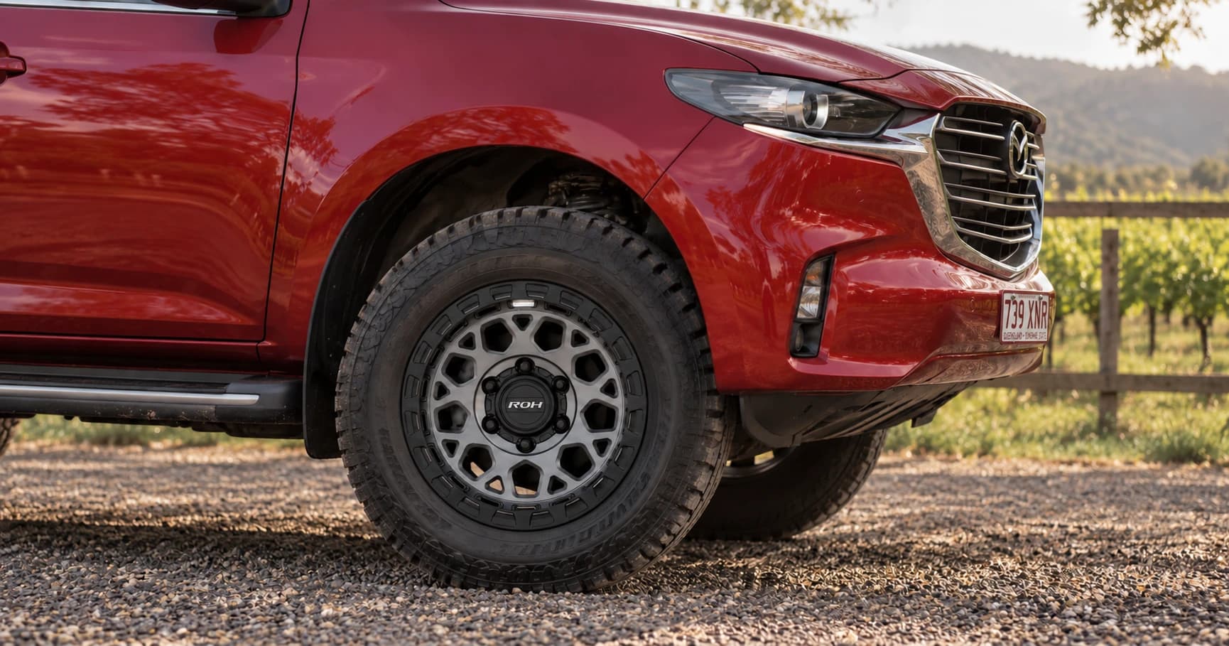 Front-wheel detail of a 2024 Mazda BT-50 GT 4x4 dual cab with ROH Atlas wheels in Graphite Centre Black Lip