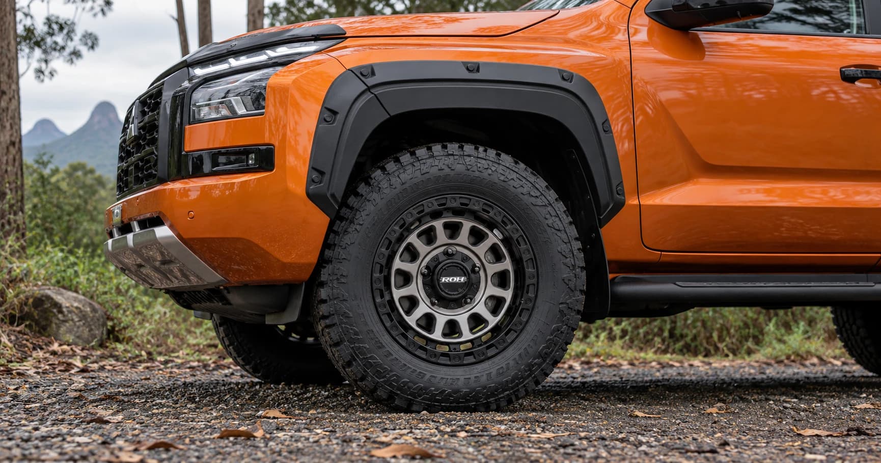 Front-wheel detail of a 2024 Mitsubishi Triton GSR 4x4 double cab with ROH Assault wheels in Graphite Centre Black Lip
