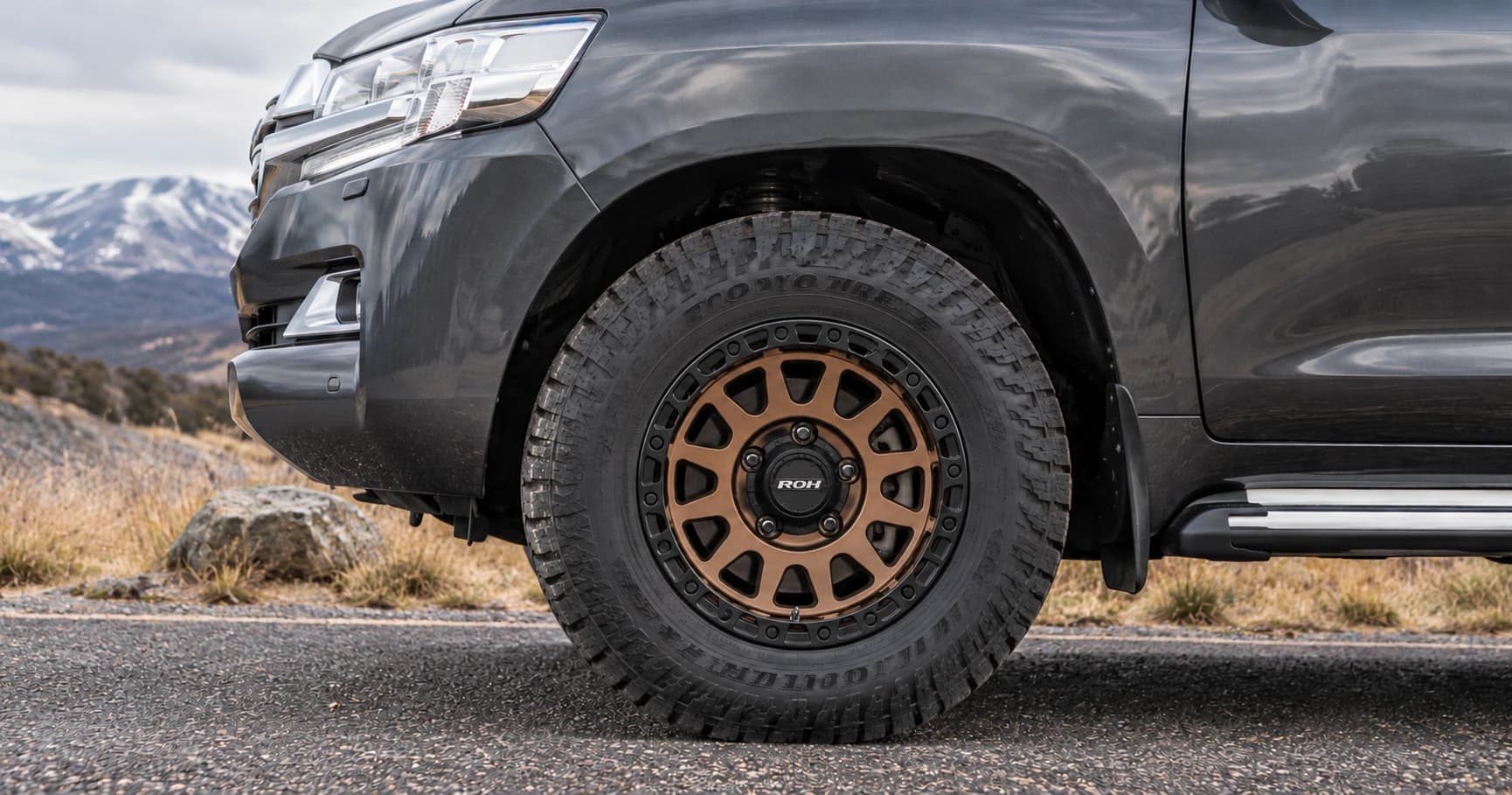 Front-wheel detail of a 2020 Toyota LandCruiser 200 GXL 4x4 with ROH Assault wheels in Bronze Centre Black Lip