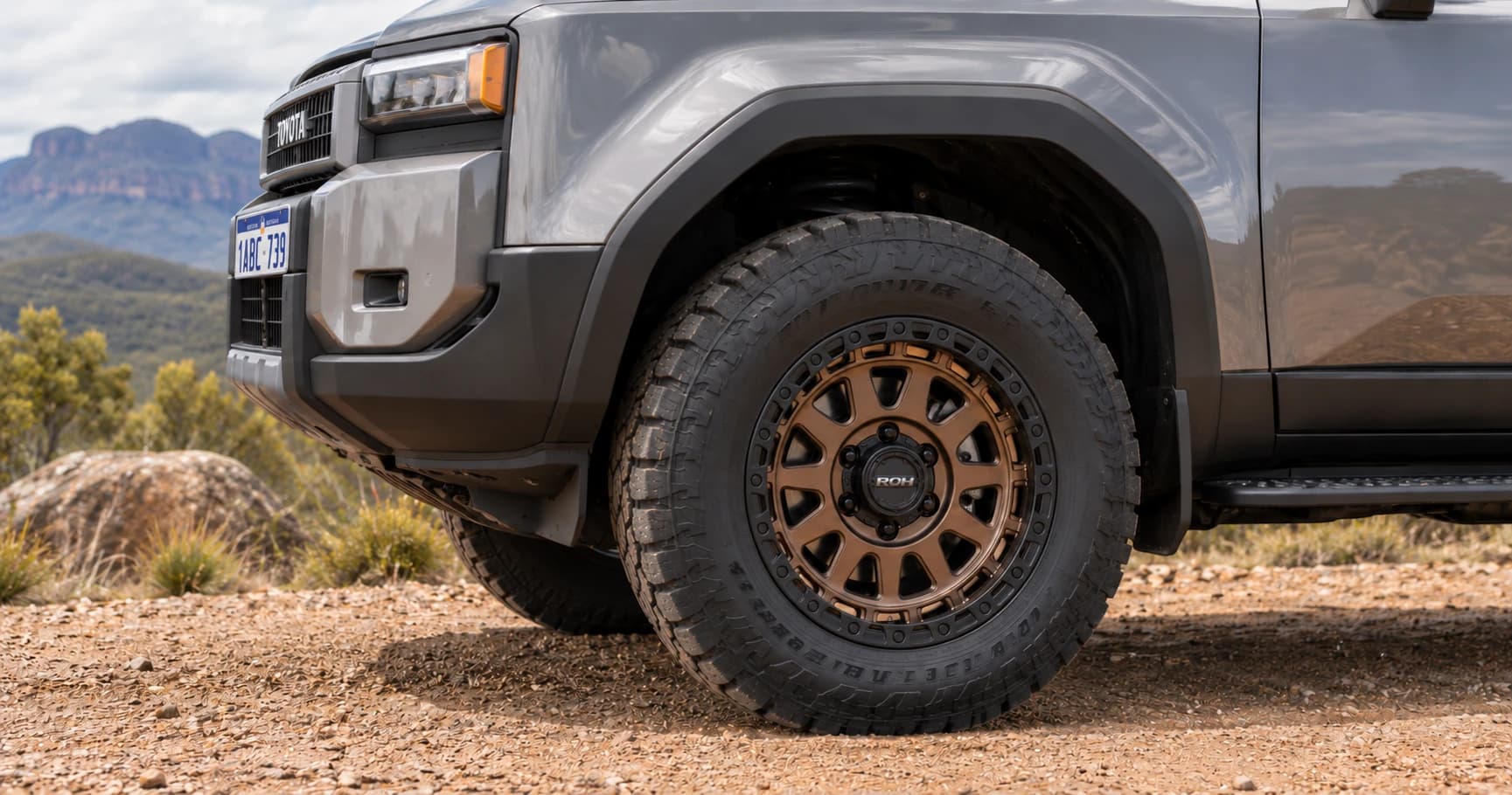 Front-wheel detail of a 2025 Toyota Prado GXL 4x4 with ROH Assault wheels in Bronze Centre Black Lip