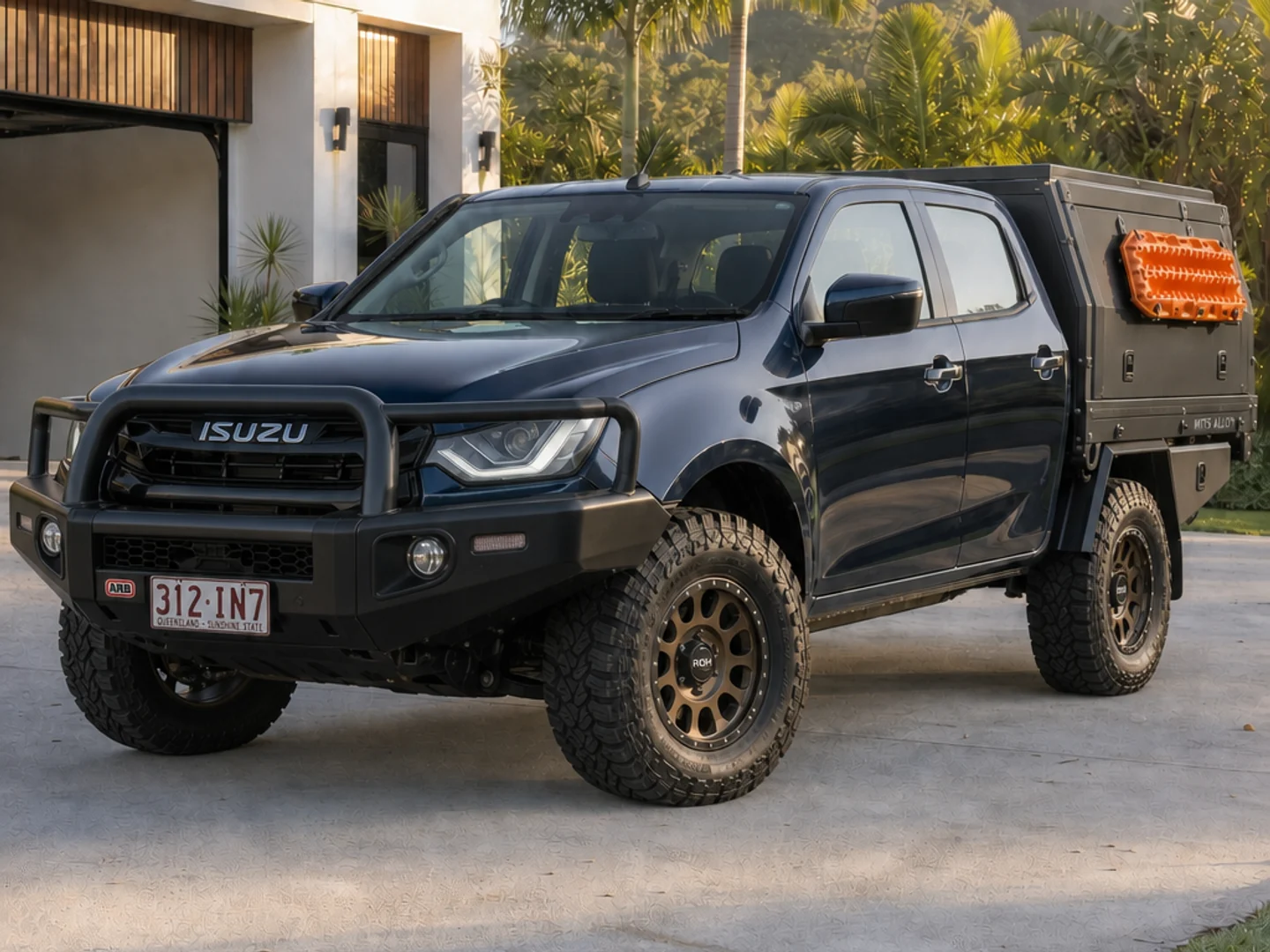 Navy Isuzu D-MAX with a bull bar, touring canopy and bronze wheels
