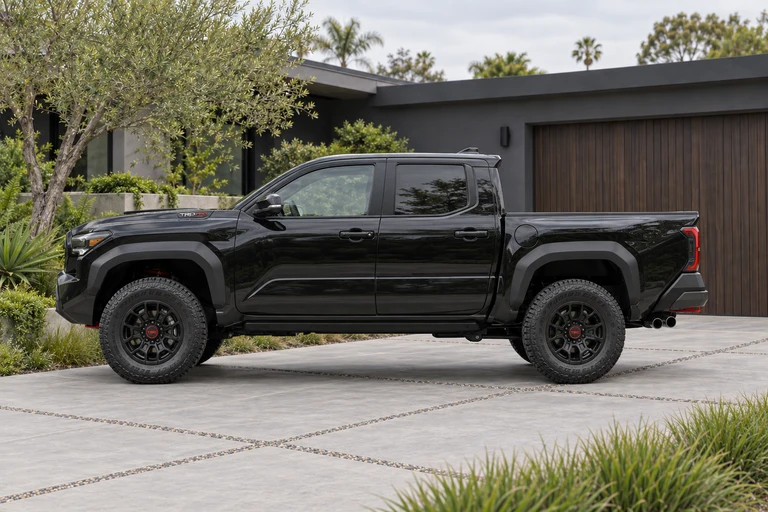 Example: side on photo of a black Toyota Tacoma on a driveway